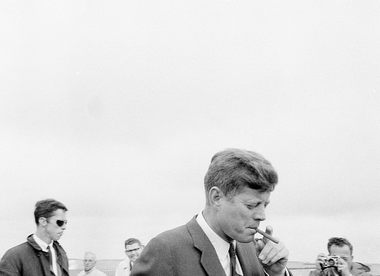 President John F. Kennedy smoking a cigar at Hyannis Port