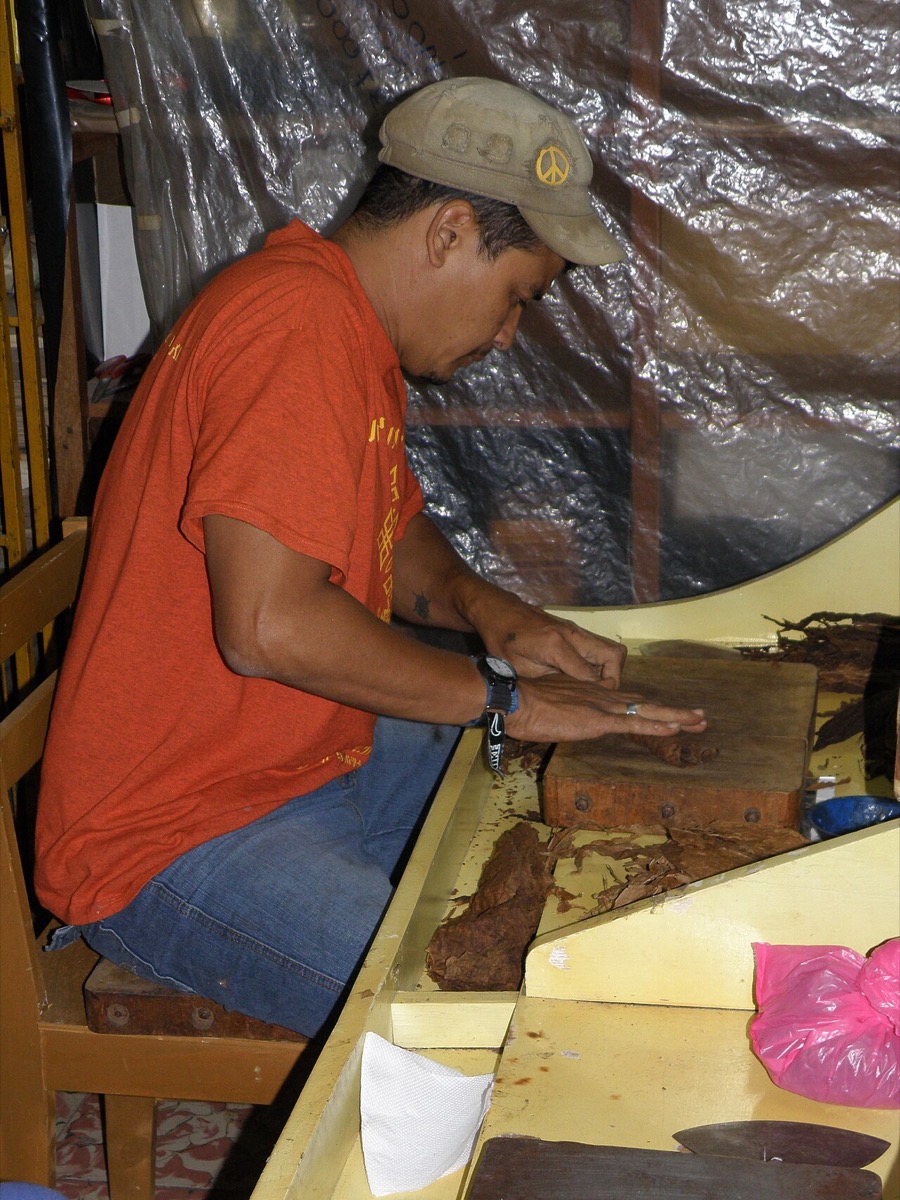 A roller hand-making cigars at a bench in Esteli, Nicaragua