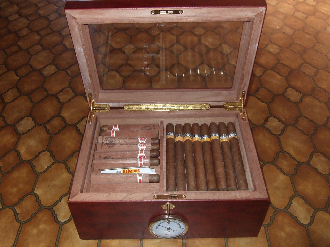 Assorted cigars of varying ring gauges displayed in a humidor