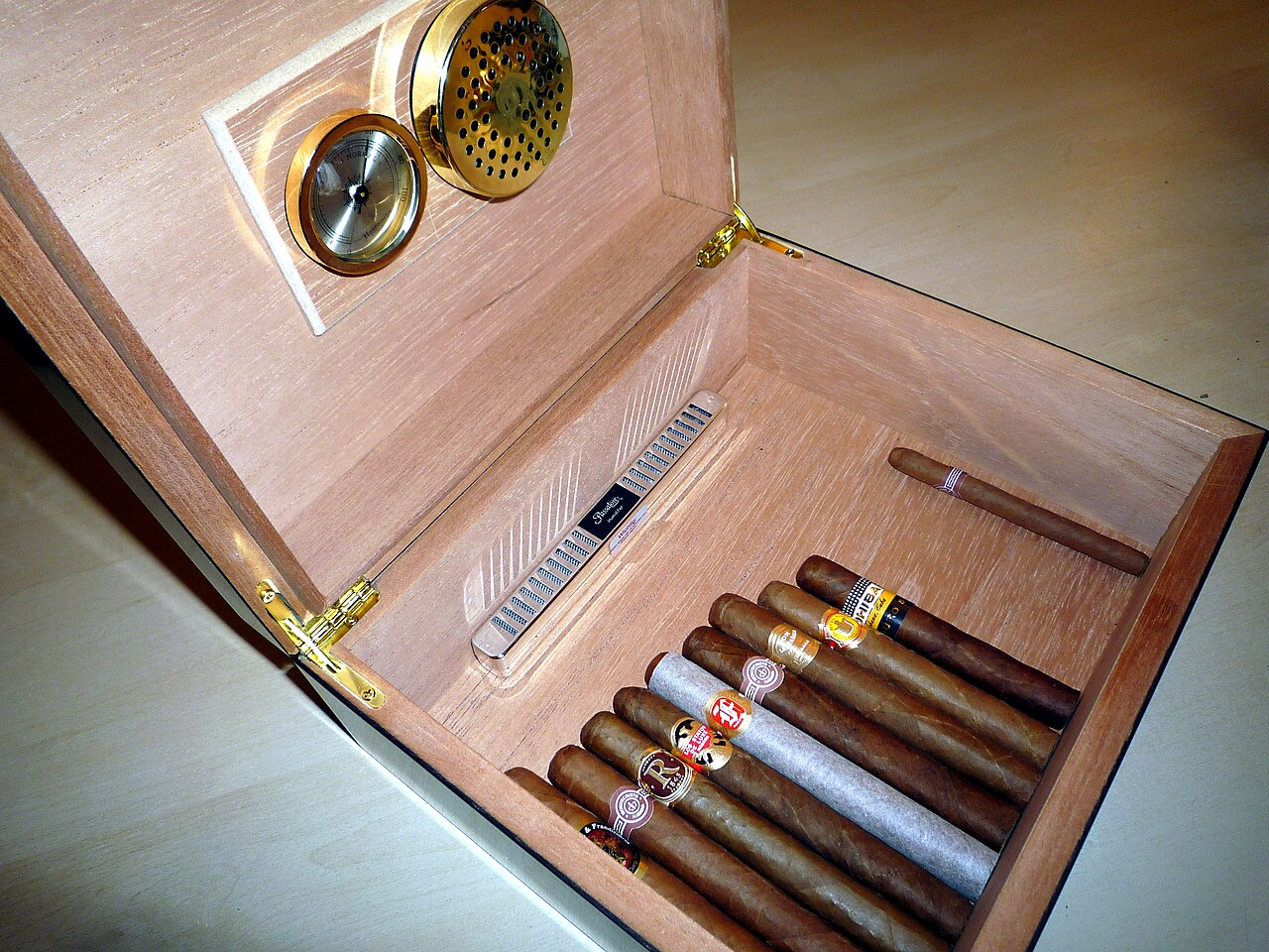 Cigars resting inside an open humidor
